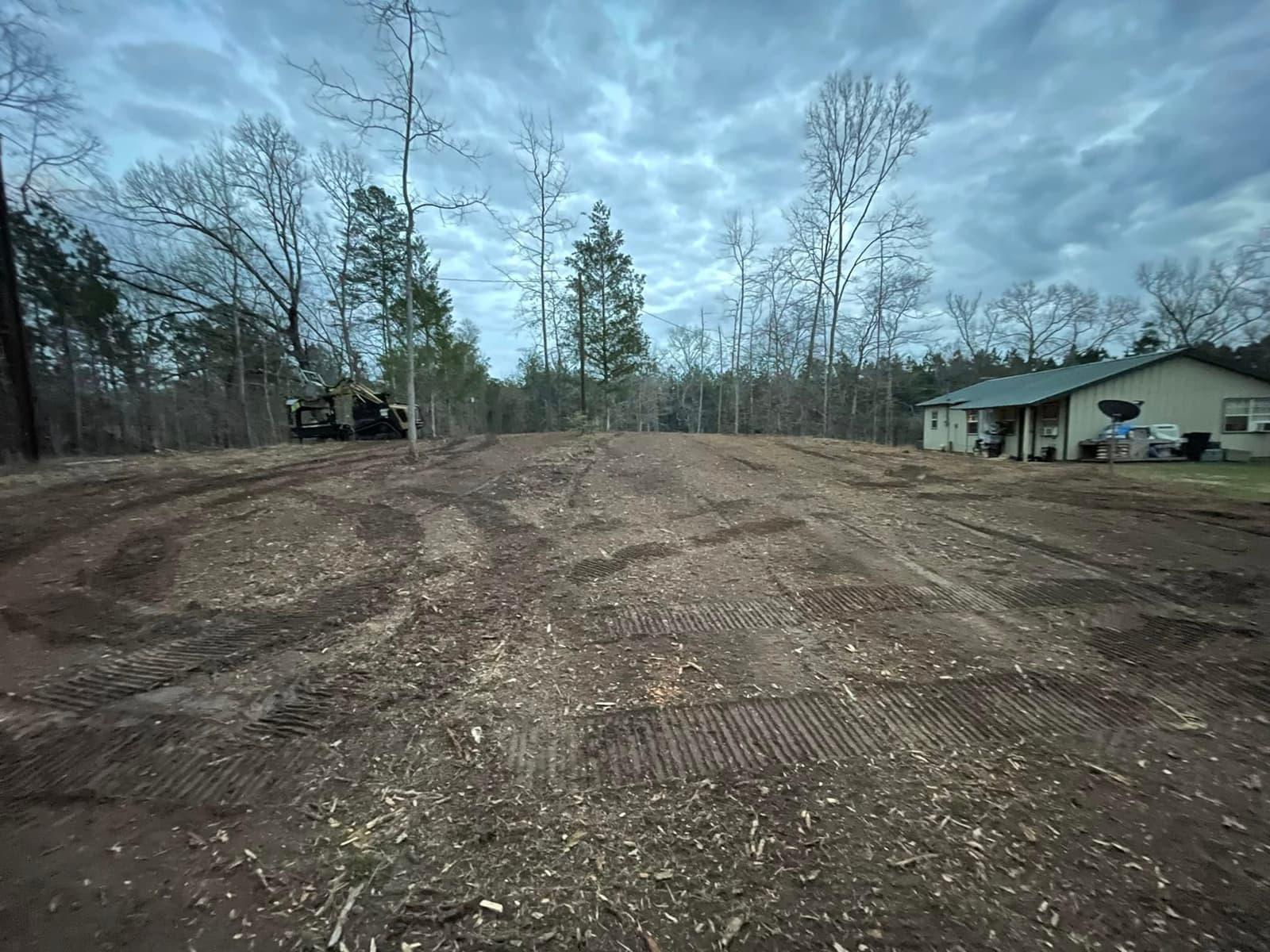 Same homesite graded smooth with compaction track marks, ready for house pad construction